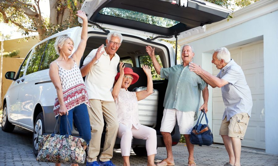 Portrait Of Excited Senior Friends Loading Luggage Into Trunk Of Car About To Leave For Vacation transport-vehicle